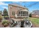 Backyard patio with stone fire pit and screened in back porch for enjoying the outdoors at 3025 Osterley St, Raleigh, NC 27614