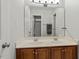 Bathroom with double sink vanity, wood cabinet, and large mirror at 3025 Osterley St, Raleigh, NC 27614