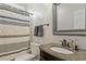 Updated bathroom features marble countertop, decorative mirror and striped shower curtain at 3025 Osterley St, Raleigh, NC 27614