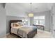 Bright bedroom features a queen bed with a window and desk at 3025 Osterley St, Raleigh, NC 27614