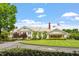 Clubhouse with immaculate green lawn and foliage on a sunny day at 3025 Osterley St, Raleigh, NC 27614