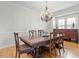 Formal dining room with chandelier and wooden dining table set at 3025 Osterley St, Raleigh, NC 27614