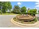 Community entrance sign with landscaping and foliage with a blue sky at 3025 Osterley St, Raleigh, NC 27614