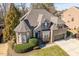 Beautiful brick home featuring a well-maintained lawn and charming architectural details at 3025 Osterley St, Raleigh, NC 27614