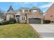 Attractive brick home with a two-car garage, well-maintained lawn, and a welcoming entrance at 3025 Osterley St, Raleigh, NC 27614