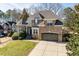 Beautiful brick home featuring a well-maintained lawn and charming architectural details at 3025 Osterley St, Raleigh, NC 27614