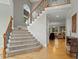 Inviting foyer with wood floors, staircase, and a view into the living room at 3025 Osterley St, Raleigh, NC 27614