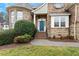 Home exterior with a quaint entrance featuring brick steps and lush greenery at 3025 Osterley St, Raleigh, NC 27614