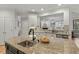 Spacious kitchen with a large island, granite countertops, and open view to the living room at 3025 Osterley St, Raleigh, NC 27614