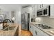 The modern kitchen features stainless steel appliances, granite countertops, and a gas cooktop at 3025 Osterley St, Raleigh, NC 27614