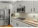 Bright kitchen features white cabinets, stainless steel appliances, granite countertops, and gas cooktop at 3025 Osterley St, Raleigh, NC 27614