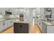 Open kitchen features granite counters, center island, and stainless appliances at 3025 Osterley St, Raleigh, NC 27614