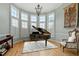 Bright living room featuring large windows, a grand piano, and stylish decor at 3025 Osterley St, Raleigh, NC 27614