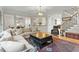 Bright living room with staircase, hardwood floors, and decorative rug at 3025 Osterley St, Raleigh, NC 27614
