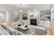 Bright living room features fireplace, built-in shelving, and staircase at 3025 Osterley St, Raleigh, NC 27614