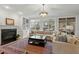 Spacious living room with a fireplace, built-in shelving, and natural light at 3025 Osterley St, Raleigh, NC 27614