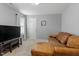 Spacious living room featuring a comfortable leather sofa and a TV at 3025 Osterley St, Raleigh, NC 27614