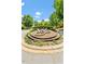 Scenic roundabout with decorative landscaping and community signage, creating a welcoming entrance at 3025 Osterley St, Raleigh, NC 27614