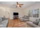 Comfortable living room features a ceiling fan, hardwood floors, and lots of natural light at 3102 Seth Dr, Sanford, NC 27330