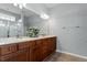 This bathroom features a double vanity with a marble countertop and dark wood cabinets at 314 Fenmore Pl, Cary, NC 27519