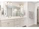 Elegant bathroom with double sinks, a large mirror, and a separate glass-enclosed shower, offering luxury and comfort at 349 Shadow Falls Dr, Wendell, NC 27591