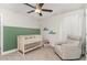 Charming Bedroom with a crib, recliner, and decorative accents, creating a cozy and welcoming space for baby at 349 Shadow Falls Dr, Wendell, NC 27591