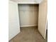 Spacious walk-in closet featuring ample shelving and neutral carpet, perfect for organization and storage at 349 Shadow Falls Dr, Wendell, NC 27591
