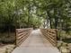 Picturesque wooden bridge surrounded by lush greenery creates a tranquil walkway at 349 Shadow Falls Dr, Wendell, NC 27591