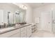 Bathroom with double vanity, framed mirrors, and a walk-in shower at 349 Shadow Falls Dr, Wendell, NC 27591