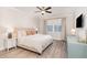 Neutral main bedroom with a ceiling fan, wood floors, and a window for natural light at 349 Shadow Fls Dr, Wendell, NC 27591