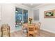 Bright dining area with wood floors, walk-out to screened in porch, and a wood table at 349 Shadow Fls Dr, Wendell, NC 27591