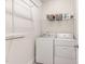 Functional laundry room with washer, dryer, shelving, and ample storage space at 349 Shadow Falls Dr, Wendell, NC 27591