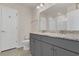 Well-lit bathroom featuring double sinks, gray vanity, and modern fixtures at 3512 Dragonfly River Ct, Raleigh, NC 27604