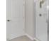 Bathroom features a white door and a glass-enclosed shower with a gold shower head at 3512 Dragonfly River Ct, Raleigh, NC 27604