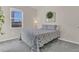Well-lit bedroom featuring a bed, a floor lamp, and a window at 3512 Dragonfly River Ct, Raleigh, NC 27604