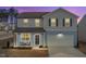Charming two-story home with a well-maintained lawn, a welcoming front porch, and an attached two-car garage at 3512 Dragonfly River Ct, Raleigh, NC 27604