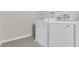 Laundry room with white washer and dryer and gray tiled floor at 3512 Dragonfly River Ct, Raleigh, NC 27604