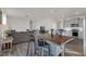 Open-concept living space featuring a kitchen island with seating, and a comfortable gray sectional at 3512 Dragonfly River Ct, Raleigh, NC 27604