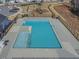 Community pool with multiple entry points, a playground in the background, and lounge chairs at 3512 Dragonfly River Ct, Raleigh, NC 27604