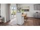 Bright dining area with wood table, stylish chairs, gray cabinets, and sliding door access to the outdoor space at 369 Swift Creek Farm Ln, Clayton, NC 27520