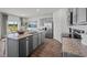 Spacious kitchen with a large island, stainless steel appliances, granite countertops, and wood flooring at 369 Swift Creek Farm Ln, Clayton, NC 27520