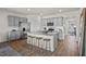 Modern kitchen featuring gray cabinets, a granite island with bar stools, and stainless steel appliances at 369 Swift Creek Farm Ln, Clayton, NC 27520