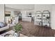 Open-concept living space with hardwood floors, gray cabinets, a kitchen island, dining area, and inviting seating at 369 Swift Creek Farm Ln, Clayton, NC 27520
