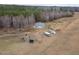 An aerial view of a house, yard, and trees, including a trampoline and RV at 375 Thomas Arnold Rd, Zebulon, NC 27597