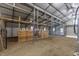 Interior view of large barn structure with metal frame and wood dividers at 375 Thomas Arnold Rd, Zebulon, NC 27597
