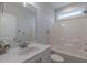 Bathroom features a tub-shower combo with a white vanity and bright natural light at 375 Thomas Arnold Rd, Zebulon, NC 27597