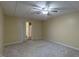 A cozy bedroom featuring modern ceiling fan, neutral color scheme, and an adjoining bathroom with a sliding door at 375 Thomas Arnold Rd, Zebulon, NC 27597