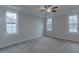 Bright bedroom with plush carpeting, recessed lighting, and large windows providing outdoor views at 375 Thomas Arnold Rd, Zebulon, NC 27597
