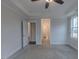 Spacious bedroom with neutral carpeting, ceiling fan, and bright natural light from windows at 375 Thomas Arnold Rd, Zebulon, NC 27597