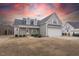 Charming two-story home with gray siding and an attached two-car garage at sunset at 375 Thomas Arnold Rd, Zebulon, NC 27597